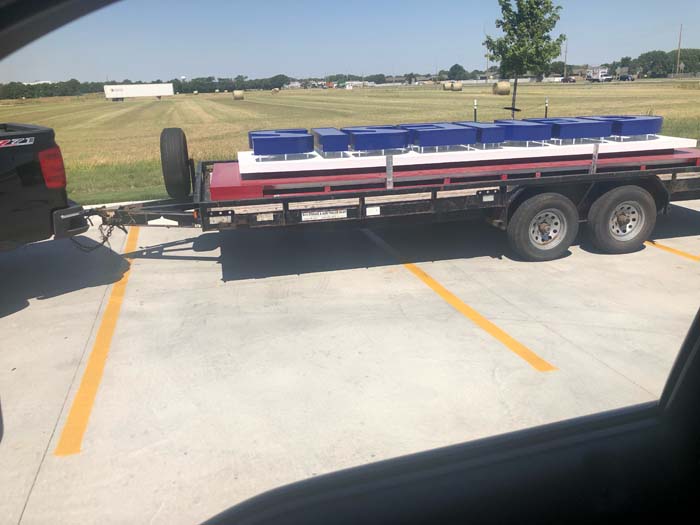 Genesis Health Clubs sign being transported on a trailer