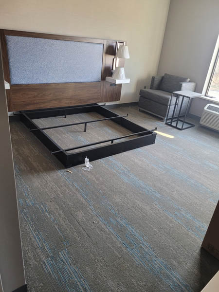 Furniture being installed inside room at Hampton Inn